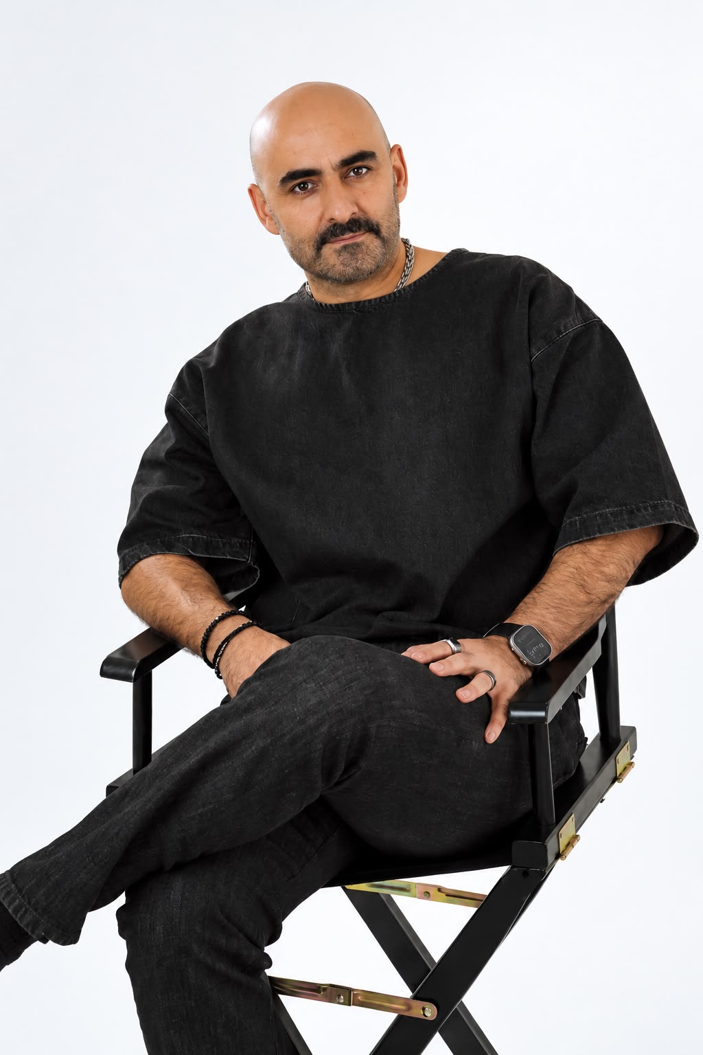 Matt Ekinci seated in a studio portrait